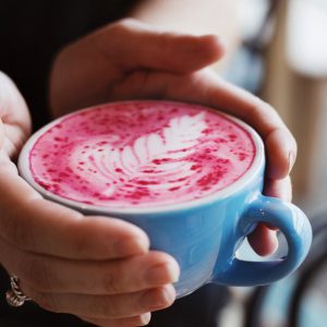 Nutra Organics Velvet Latte drink in a blue cup