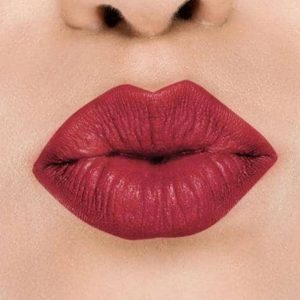 Raww - Coconut Kiss Lipstick in the shade of Candy Apple with a closeup image applied to a woman's puckered lips