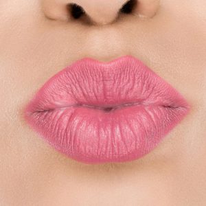 Raww - Coconut Kiss Lipstick in the shade of Petite Peach with a closeup image applied to a woman's puckered lips