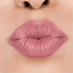Raww - Coconut Kiss Lipstick in the shade of Pomegranate Parade with a closeup image applied to a woman's puckered lips