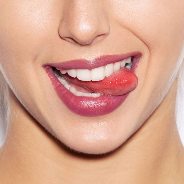 Closeup image of woman's lips wearing Raww - Fruit Fusion Lip Oil in the shad of raspberry ice