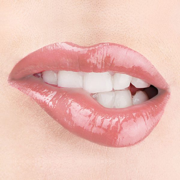 Raww - Coconut Splash Lip Gloss in the shade of Barefoot closeup image on a woman's lips