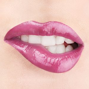 Raww - Coconut Splash Lip Gloss in the shade of Tankini closeup image on a woman's lips