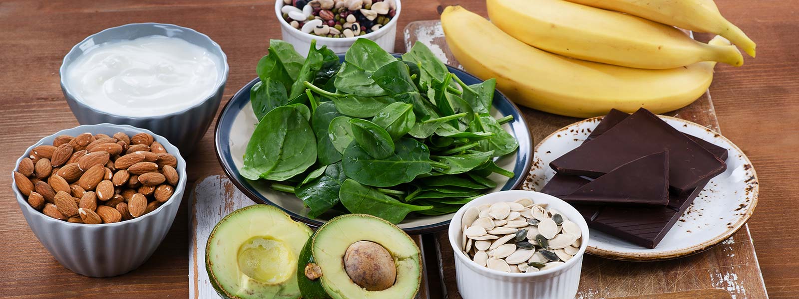 Table displayed with all Vegan Natural Foods including nuts, avacado, baby spinach, and bananas