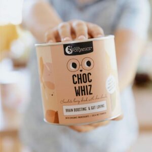 Nutra Organics Choc Whiz for kids with boy holding a 250 gram canister of the product