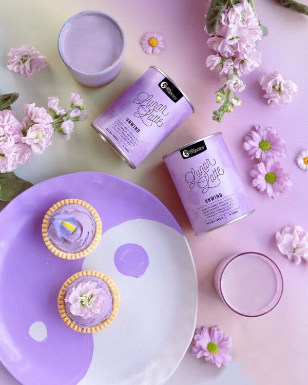 Nutra Organics Lunar Latte product container and drink displayed on a colourful purple and mauve table setting