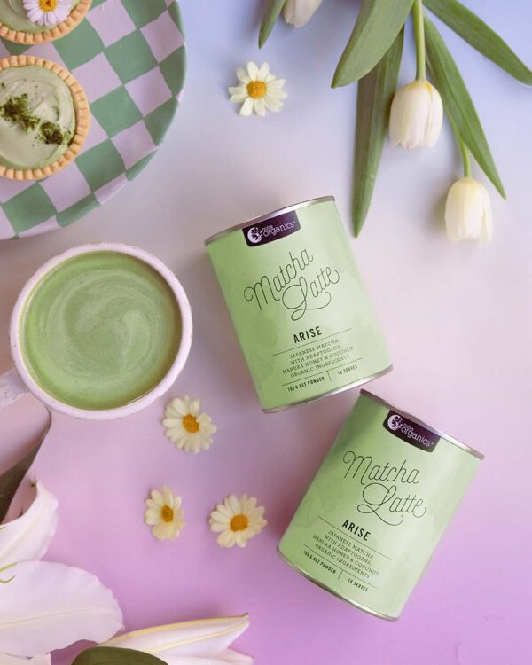 Styled image of Nutra Organics Matcha Latte drink and product containers on a colourful background