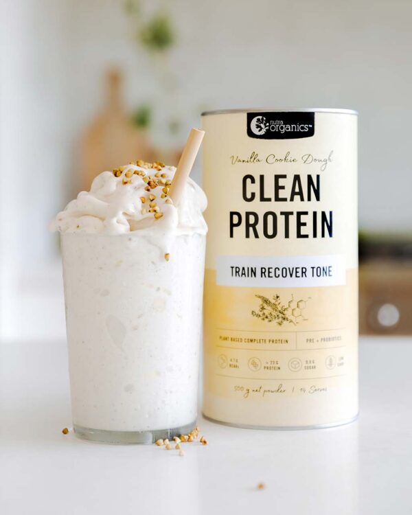 Nutra Organics Clean Protein Vanilla Cookie Dough Flavour Smoothie with product container on a kitchen table