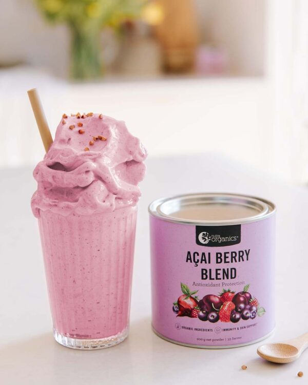 Nutra Organics Acai Berry Blend styled image with delicious creamy drink along side a container of the product