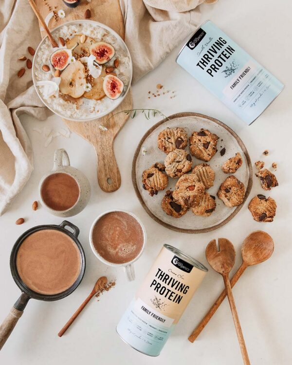 Styled image of Nutra Organics Thriving Protein displayed with drinks, oatmeal, and cookies as ways to use the product