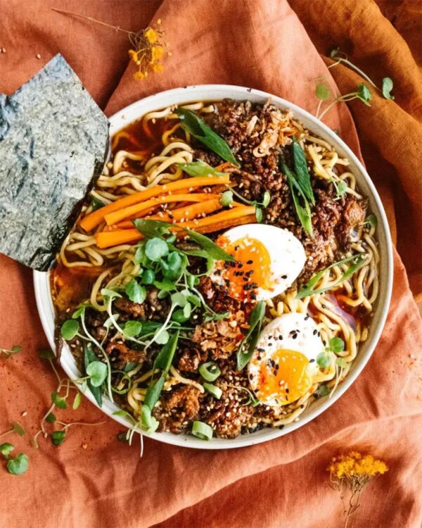 Top view of a bowl of delicious vegetables, herbs, and eggs made with Nutra Organics Beef Bone Broth in Miso Ramen Flavour